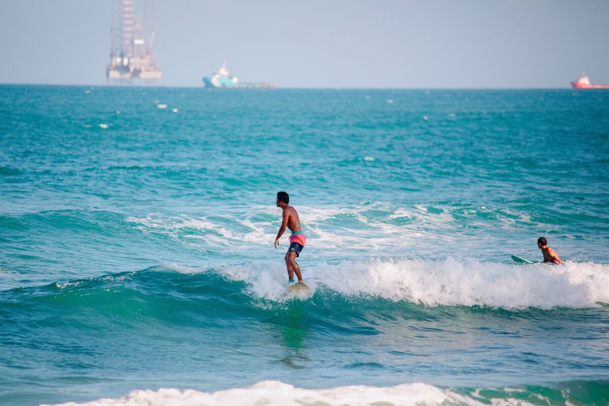 Group of surfers paddling out at a Taghazout surf break, Morocco