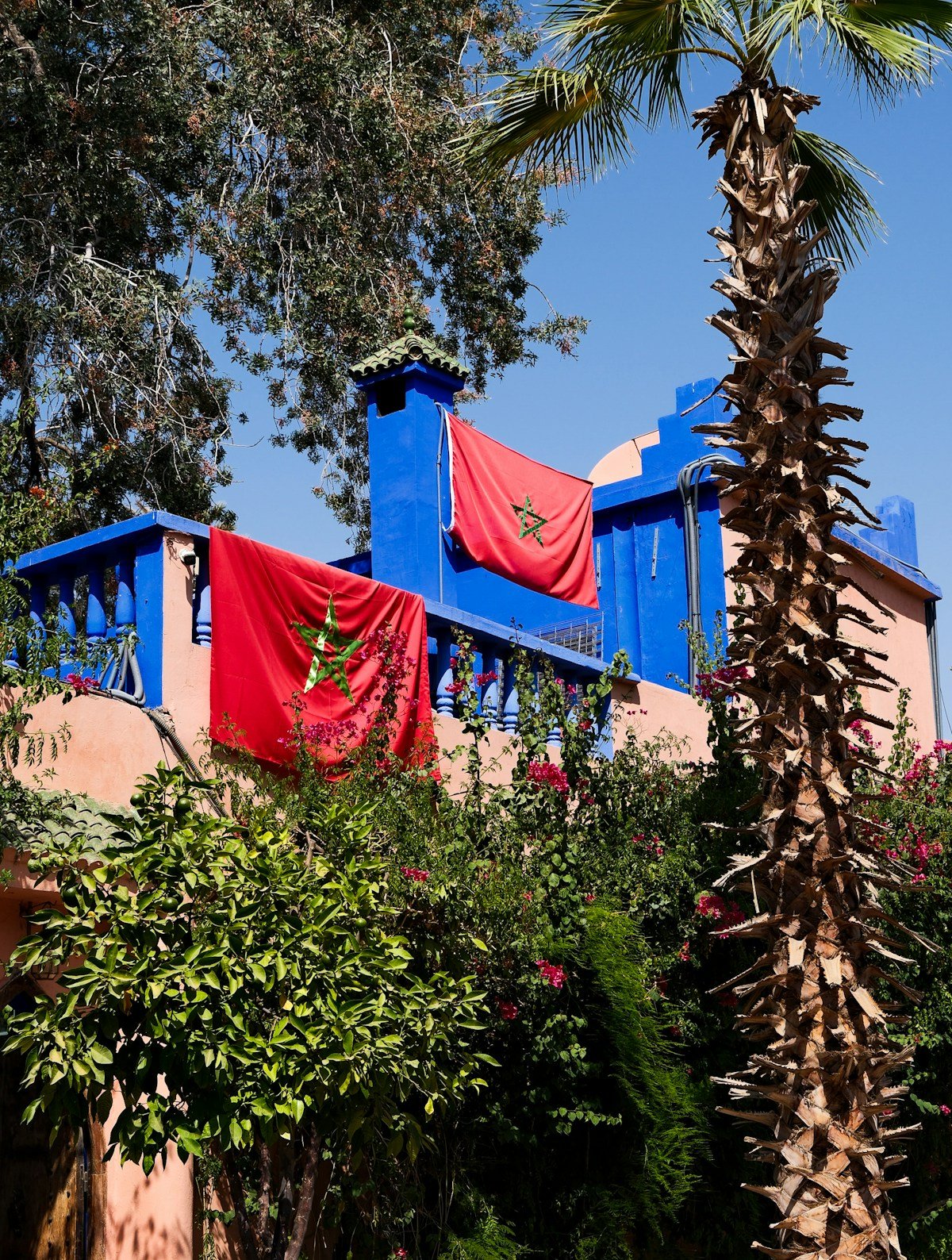 Blue building with Moroccan flags in Agadir, Morocco