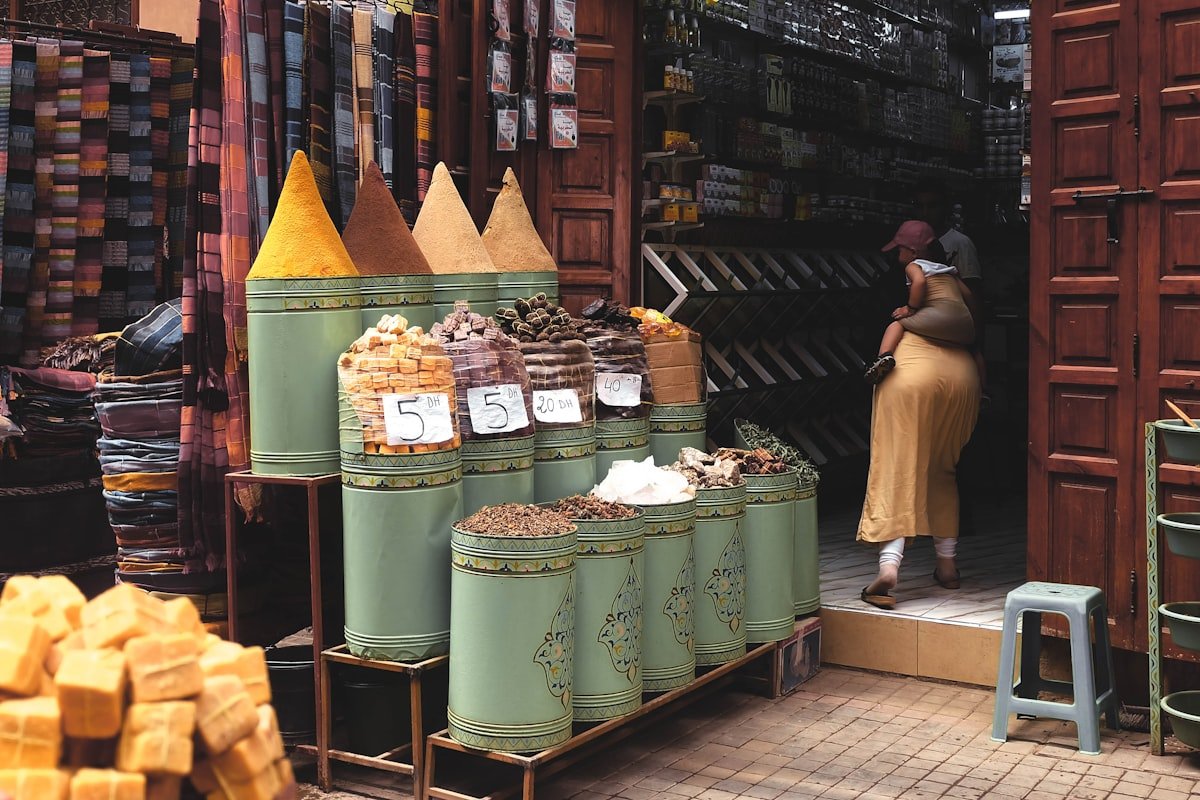 Moroccan spice market stall with conical piles of saffron, cumin, and paprika