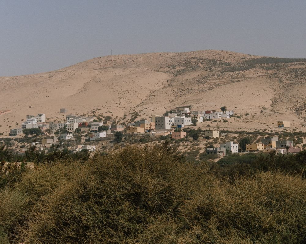 Houses of Taghazout on a dry hillside above the coast