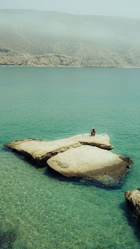 Pale rock formations in turquoise water along the Imsouane coast