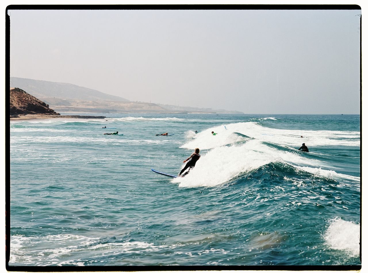 Surfers sharing a wave in a lineup off the Moroccan coast