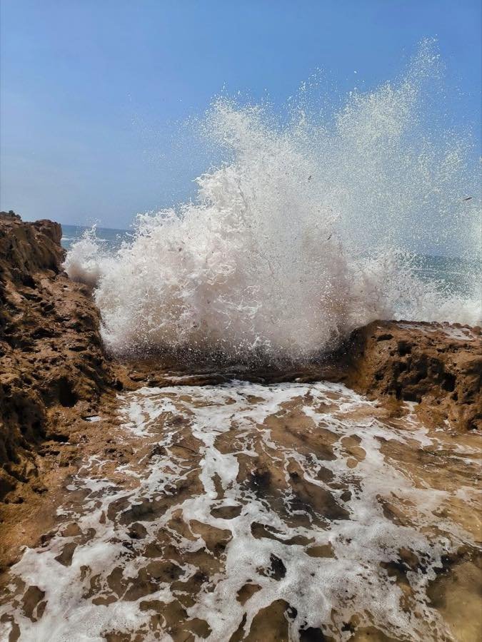 Una gran ola rompe contra las rocas de la costa atlántica