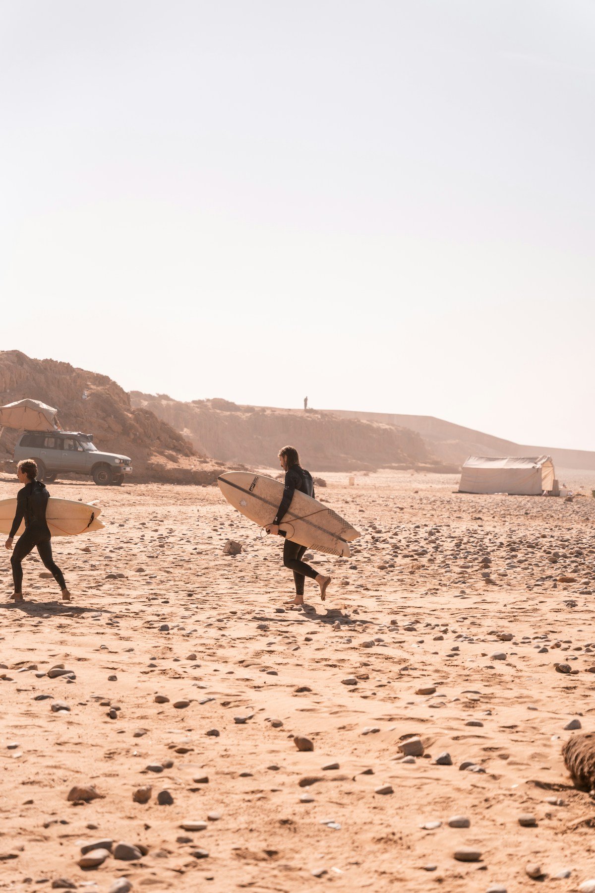 Surfers walking on the beach near Taghazout, Morocco
