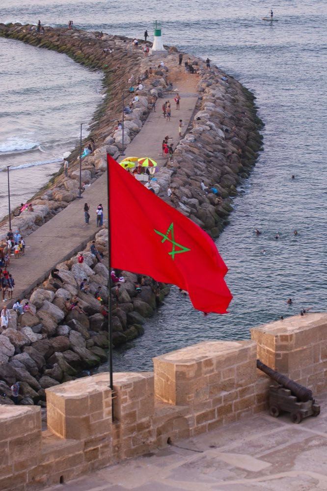 Moroccan flag flying above the seafront breakwater at Rabat