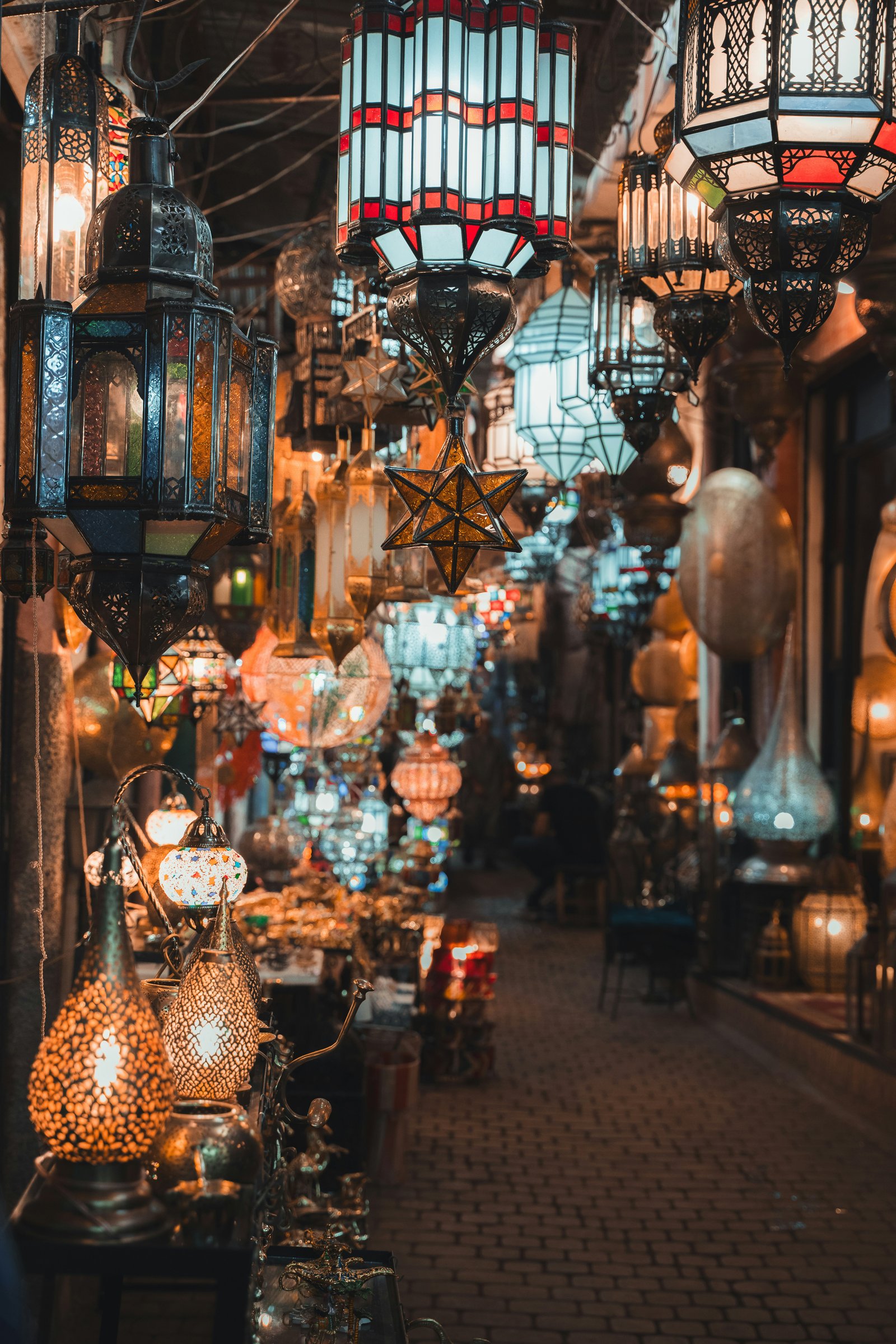 Ornate Moroccan lanterns hanging in a marketplace at night