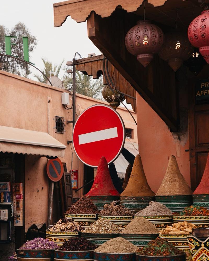Cones of colourful spices at a Marrakech souk stall