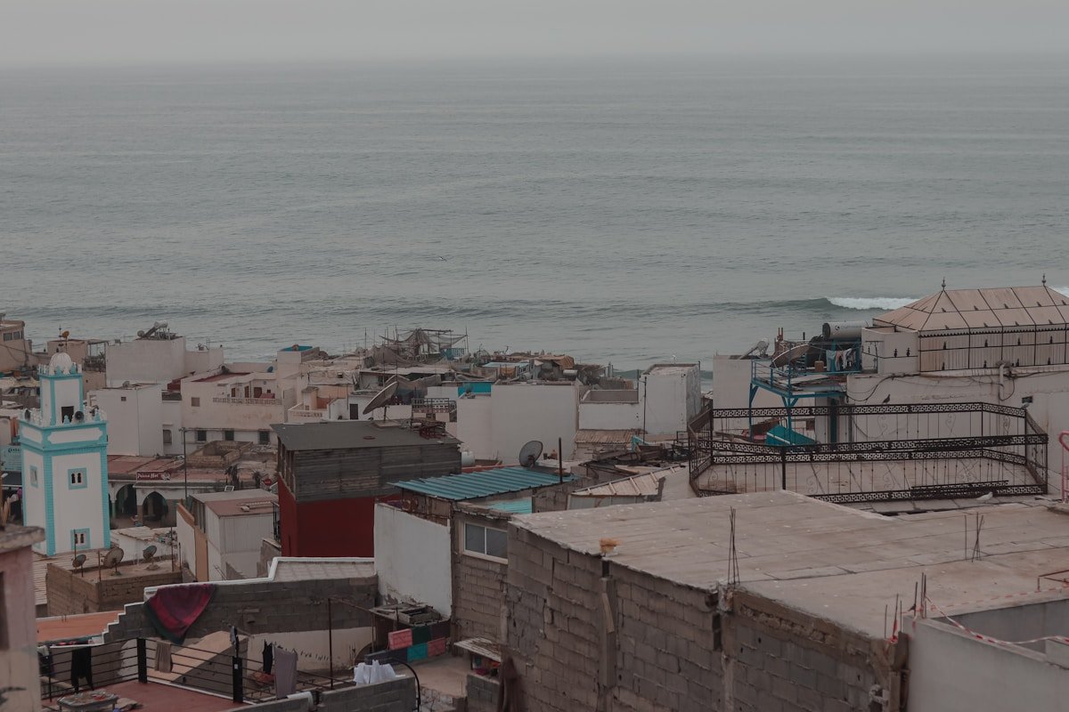 Coastal village of Taghazout with buildings and ocean waves