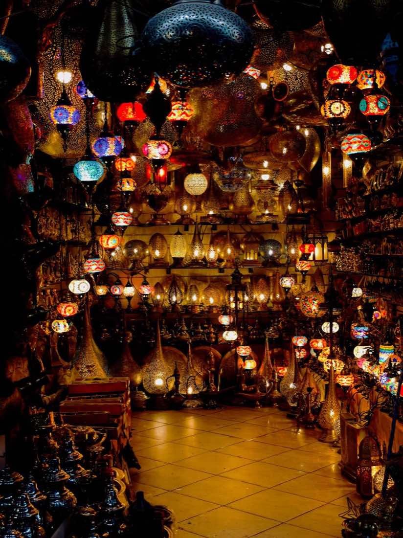 Colourful Moroccan lanterns glowing in a souk shop, a festive-season scene in Morocco