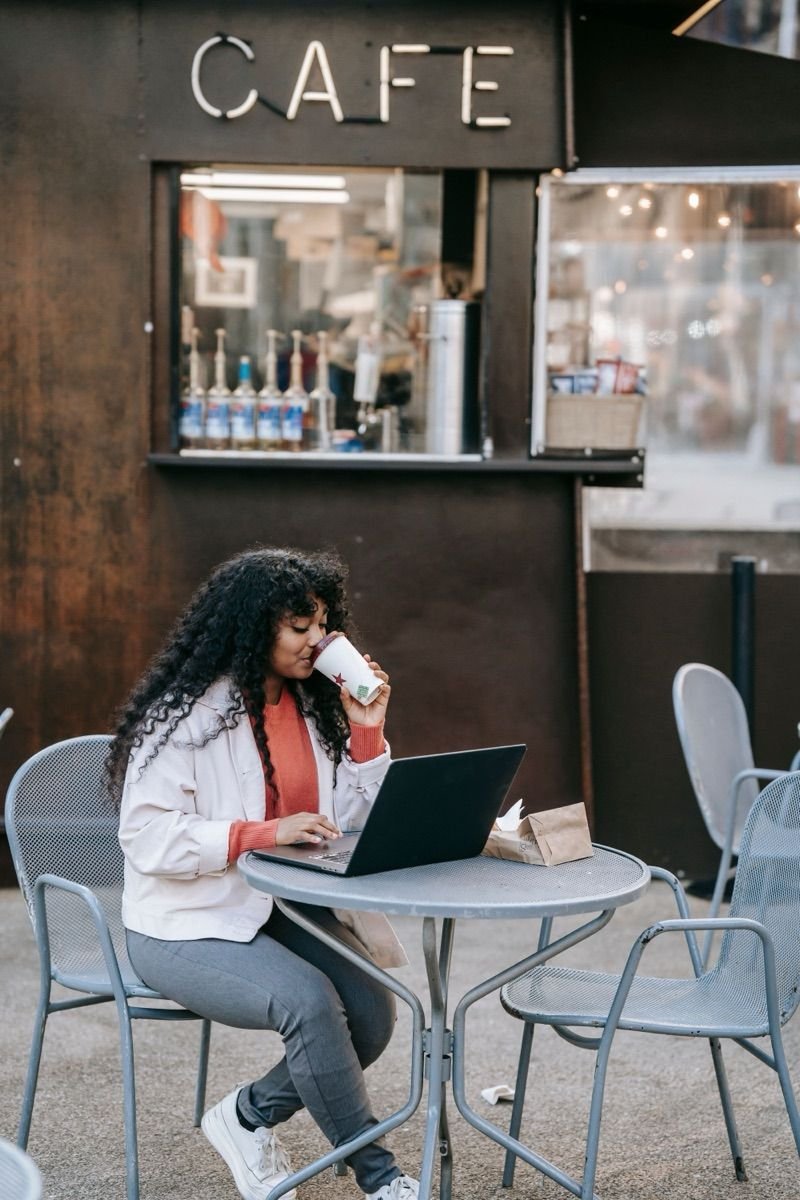 Remote worker with laptop at an outdoor café