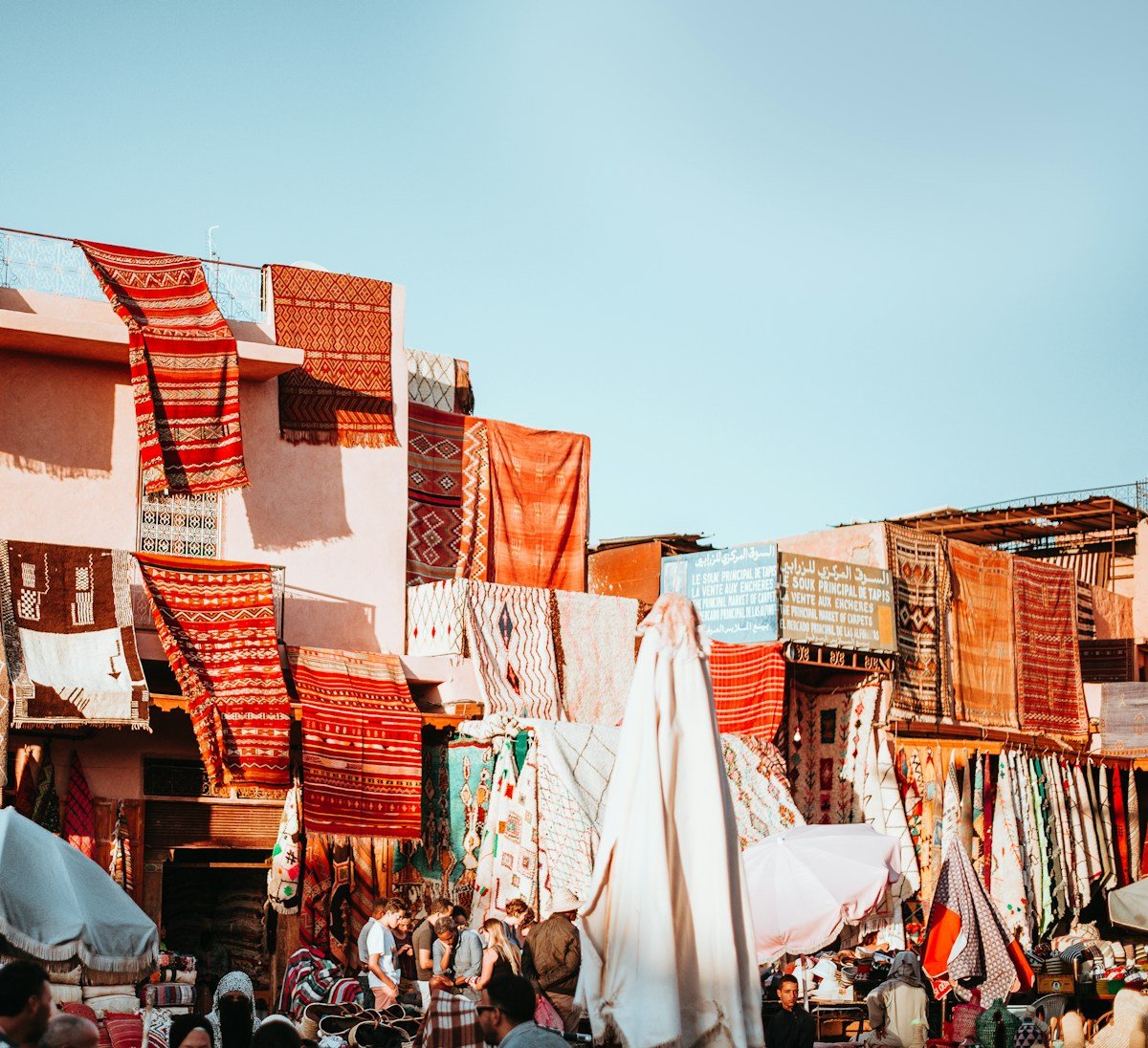 Colourful textiles and rugs hanging in a Marrakesh souk, Morocco