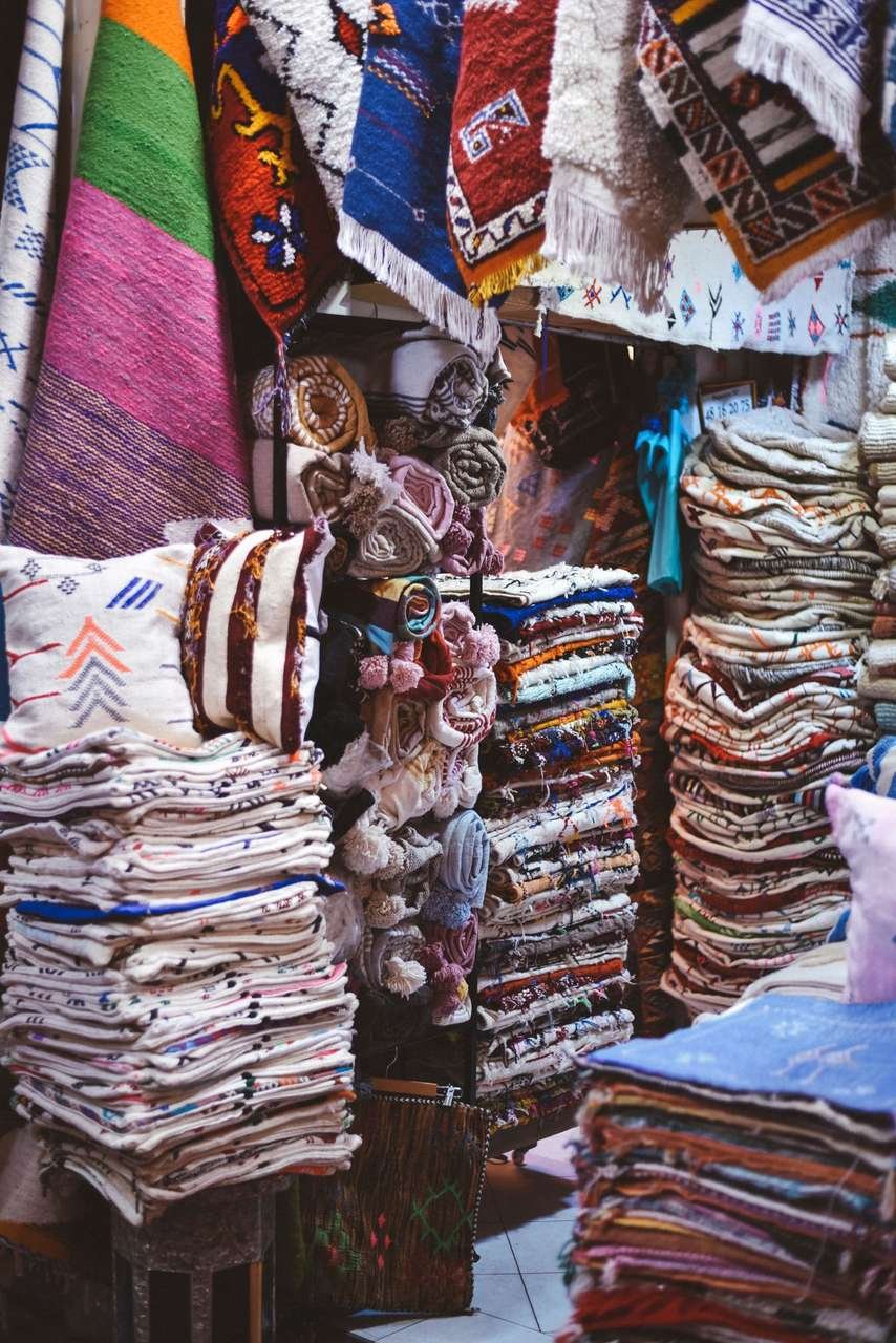 Colourful Berber rugs and textiles displayed in the Agadir souk, Morocco