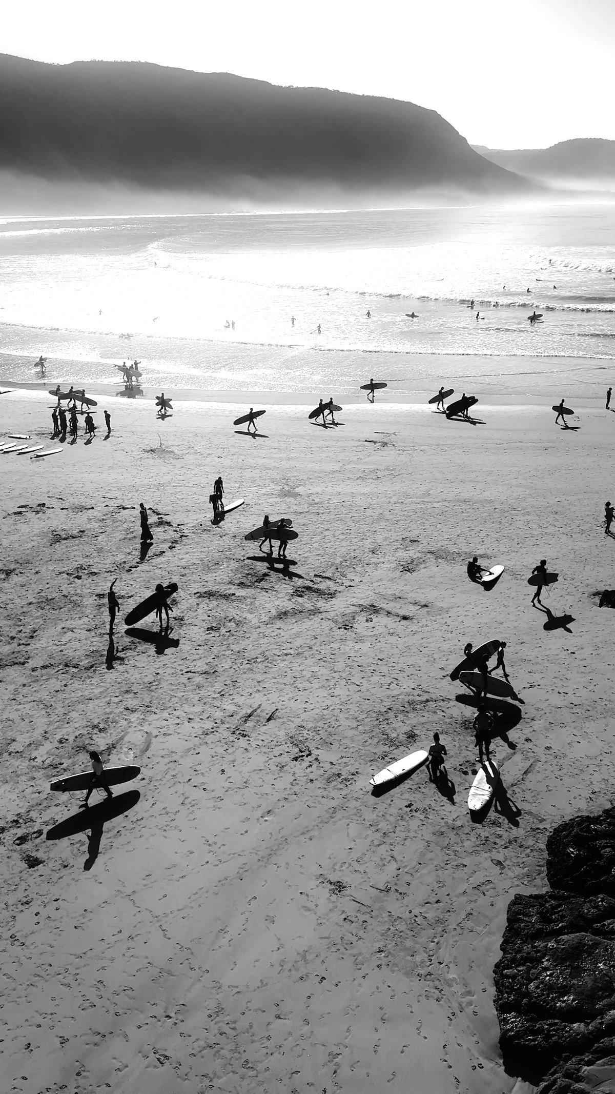Surfers with boards on beach at Imsouane, Morocco in June