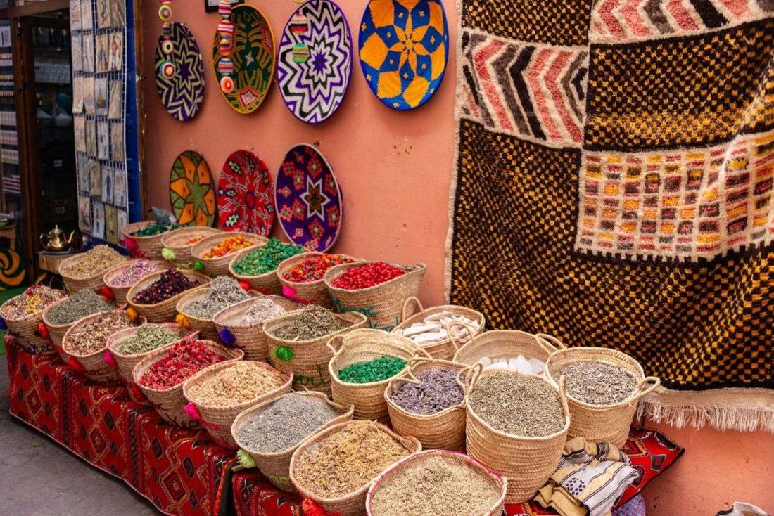 Colourful spices and textiles at a Moroccan souk market stall
