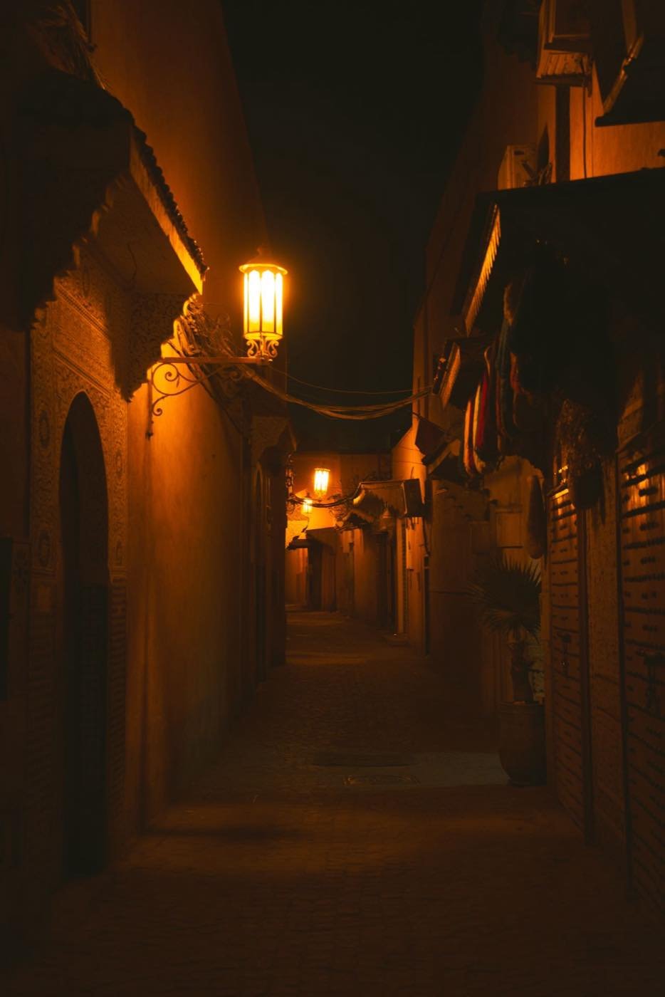 Lantern-lit alley in a Moroccan medina at night