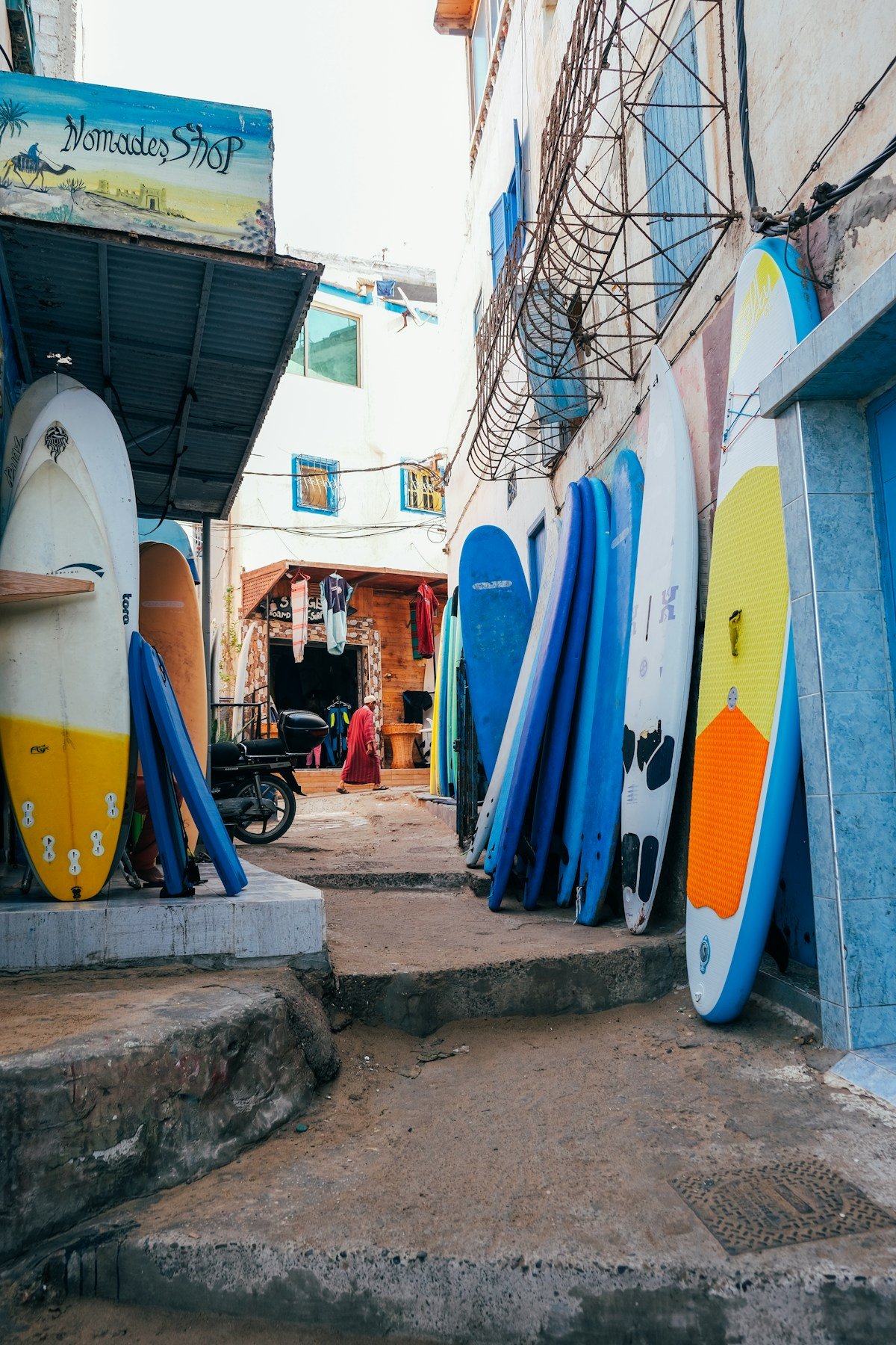 Surfboards stacked in an alleyway in Taghazout village
